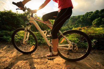 Woman cyclist cycling mountain bike on trail