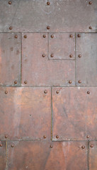 Abstract old copper with rivets as background.