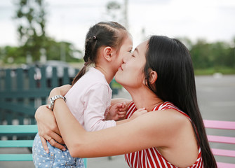 Fototapeta premium Happy loving family. mother and child girl kissing.