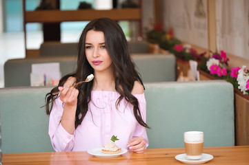 young beautiful woman eating a dessert