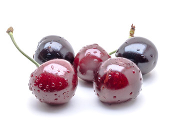 Few wet cherries on a white background