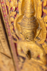 Fototapeta na wymiar Beautiful golden carving on the door of Wat Sensoukharam temple in Luang Prabang, Laos