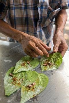 Man making betel nut on the street stall in Myanmar (Burma).