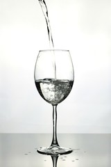 pouring water into wine glass