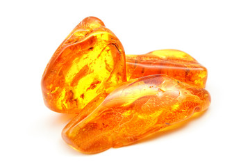 Amber. Bright yellow pieces of amber on a white background. Sunstone amber texture. Mineral for jewelry. Vintage ancient resin. Baltic amber. Colored bright pieces of amber resin