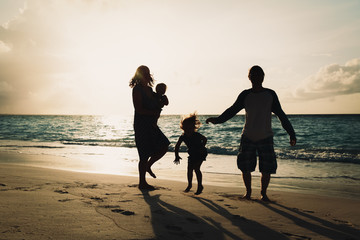 happy family with kids play at sunset beach