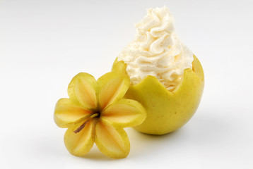 Two apples stuffed with whipped cream