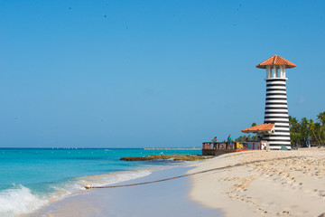 Striped red white lighthouse on the coast of the Caribbean Sea. Dominican Republic.