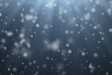 Winter christmas sky with snow falling and blurred bokeh of snow. Abstract elegant shiny silver white glitter sparkle on blue background design for christmas,and happy new year greeting card