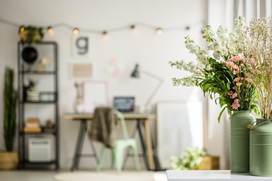 Wildflowers In Two Green Milk Jugs