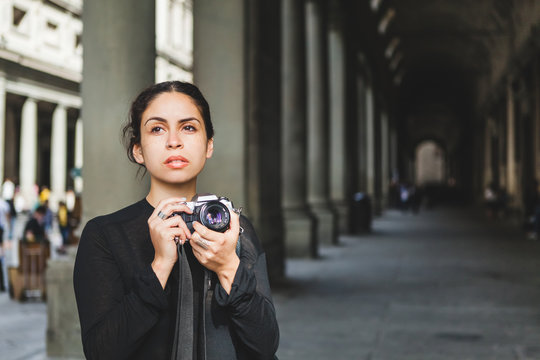 Young Woman Photographing Old Italian Architecture with an Analog Camera