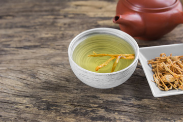 cordyceps (chong cao) tea on old and crack wooden surface with copy space, healthy beverage concept