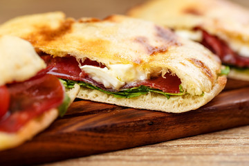 Sliced pizza calzone whith ham on wooden board