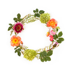 Floral round crown (wreath) with flowers and leaves. Flat lay, top view. Mother`s Day concept.