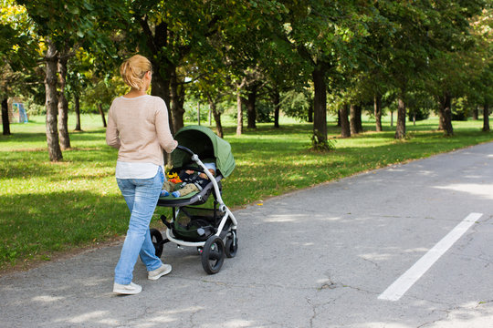 Mother Pushing Baby in a Stroller