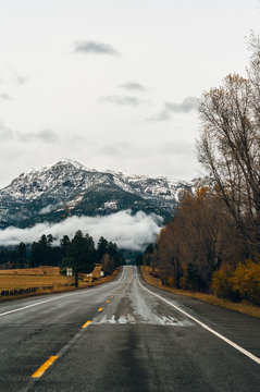Highway in showing a mountain range covered in snow