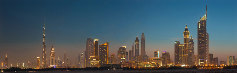 Fototapeta na wymiar DUBAI, UAE - MARCH 31, 2017: The evening skyline of Downtown with the Burj Khalifa and Emirates Towers.