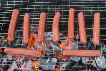 tasty hot dogs cooking on grill 