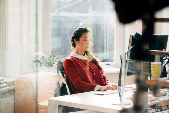 Businesswoman working on computer in office planning next business idea