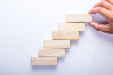 Hand arranging stacking wood block 