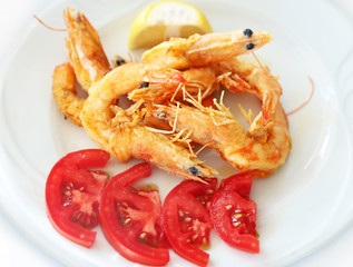 fried shrimps with fresh tomatoes at a greek tavern - delicious mediterranean seafood