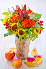 Autumn bouquet of flowers with apples and leaves . Autumn still life. 