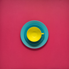 Dinner is served /Creative concept photo of kitchenware, painted plate with food on it on pink background.