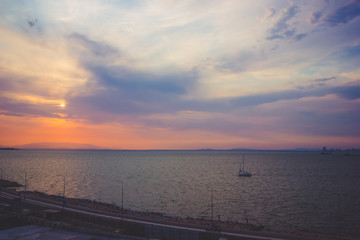 Aegean Sea in the Konak area of Izmir Turkey the view during sunset with a yacht floating on the sea toned image