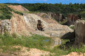 Giant excavator machinery industry. Big mine, develop mineral resources, excavator digs, cement in Lithuania