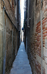 Fototapeta na wymiar Narrow street with the walls of homes almost touching