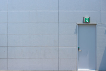 an emergency exit door with cement wall
