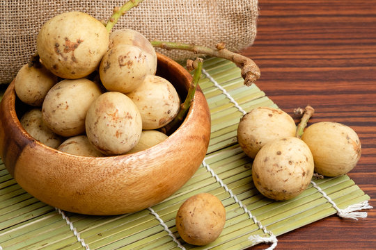Ripe lanzones fruit on wooden table