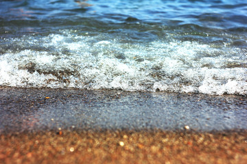 Fototapeta na wymiar Sea, ocean waves with foam on the sand. Vacation at the beach