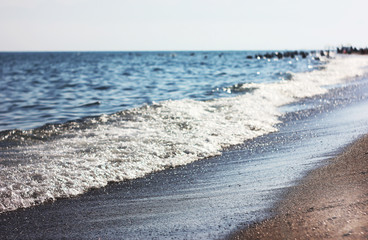 Sea shoreline, wet sand and waves. Vacation at the beach