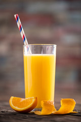 Summer orange cocktail on wooden table.