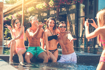Group of friends together in the swimming pool leisure