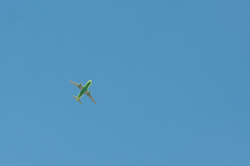 Airplane flying against the blue sky