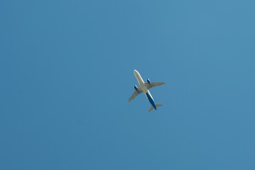 Airplane flying against the blue sky