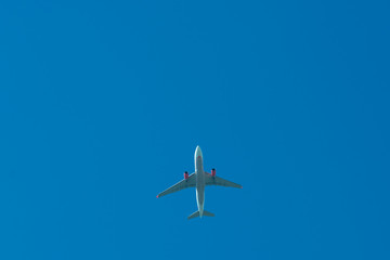Airplane flying against the blue sky