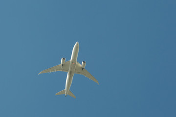 Airplane flying against the blue sky