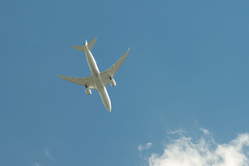 Airplane flying against the blue sky