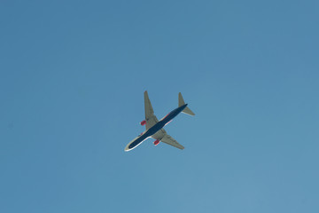 Airplane flying against the blue sky