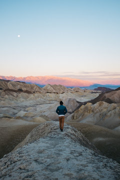 young man walking through national park at sunrise