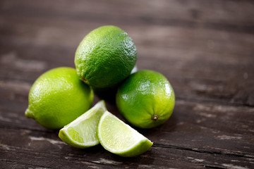 fruits, citrus, detox, diet - lime slices on wooden table.