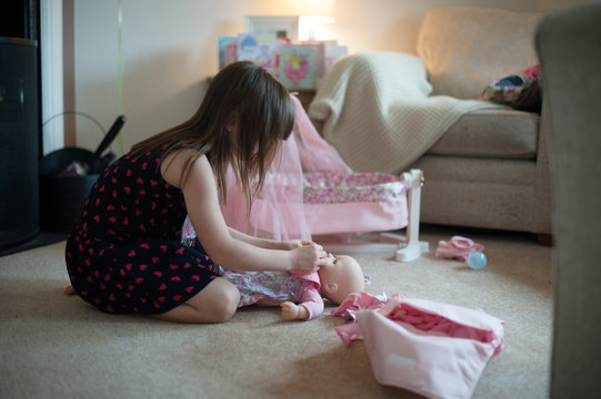 Girl playing with her doll