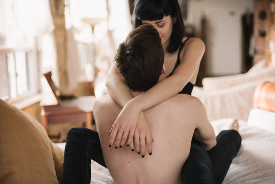 Young Topless Lovers Hugging On Bed In Industrial Loft Bedroom