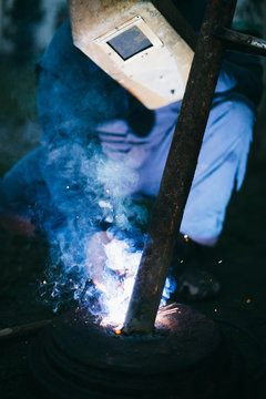 Welder welding outdoors