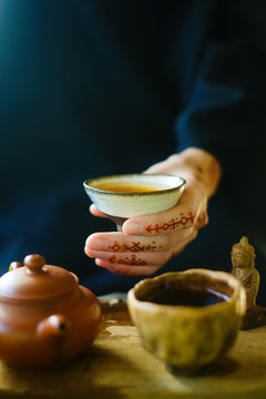 Cup of tea and tattooed hand
