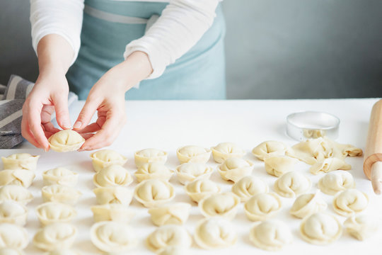 Woman making meat dumplings