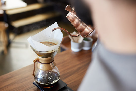 Barista pouring hot water in Chemex